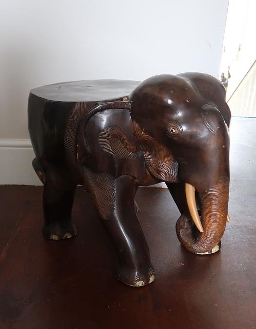A carved ebony stool modelled as an elephant, h. 41 cms, l. 64 cms.