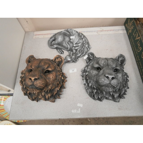 142 - 2 cast lion heads and a dragon