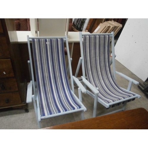 706 - Pair of painted deck chairs