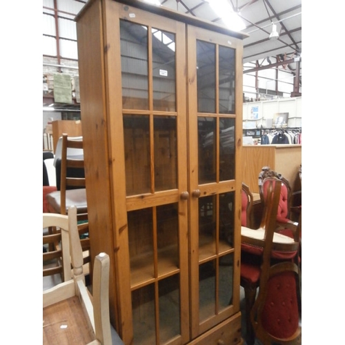 640 - Large glazed pine cabinet on drawer