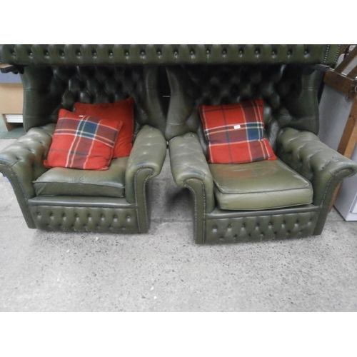 612 - Pair of green buttoned leather wing back chairs