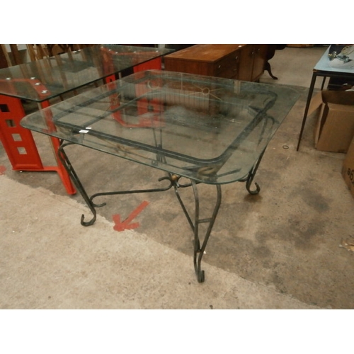 725 - Large square glass topped table on wrought iron frame