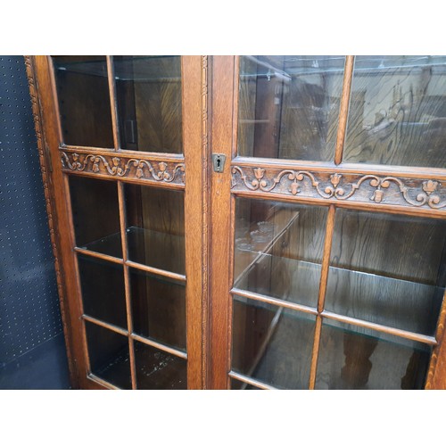 13 - Tall oak bookcase on double cupboard base with 4 glass shelves