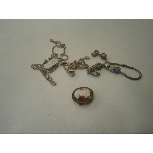 306 - Lot inc silver chain with crucifix necklace, Silver cameo brooch, Pandora bracelet and other charm b... 