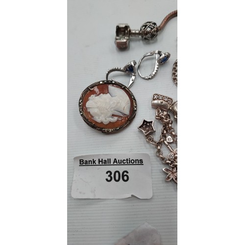 306 - Lot inc silver chain with crucifix necklace, Silver cameo brooch, Pandora bracelet and other charm b... 