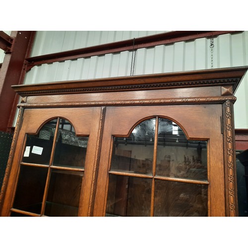 709 - Tall oak bookcase on double cupboard base with 4 glass shelves