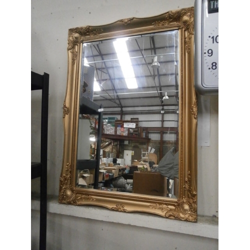 118 - Ornate gilt framed bevel edged mirror