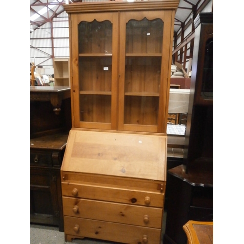 657 - A large pine 3 drawer bureau bookcase with glazed doors