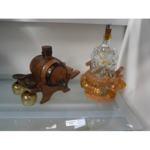 374 - Two decorative decanter sets, one with one glass missing