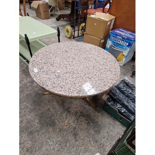 705 - A large circular coffee table with composite top on ornate gilt metal base