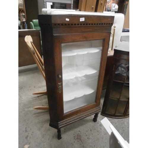 664 - An antique glazed oak corner cabinet