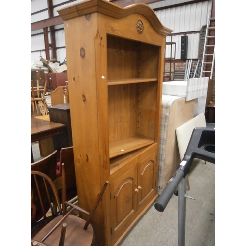 672 - A large carved pine dresser with adjustable open shelf top on double cupboard