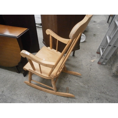 676 - A large wooden spindle back rocking chair