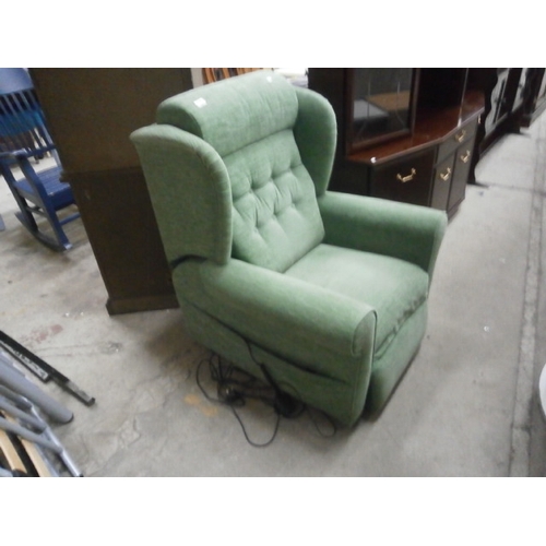 691 - An upholstered wing back electric recliner armchair