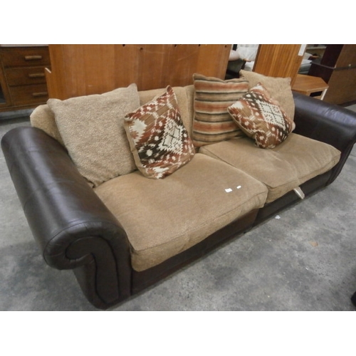 695 - A large leather and cushioned settee