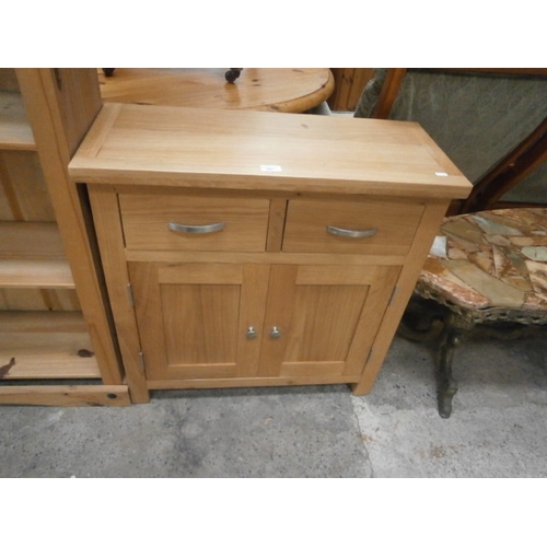 705 - A small 2 drawer light oak base unit