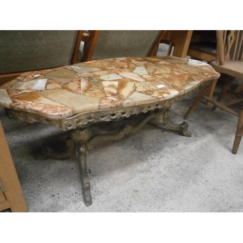 706 - A shaped composite marble topped coffee table on gilt cast metal base