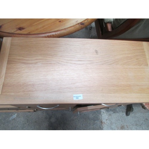 705 - A small 2 drawer light oak base unit