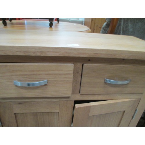 705 - A small 2 drawer light oak base unit