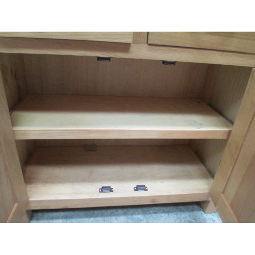 705 - A small 2 drawer light oak base unit