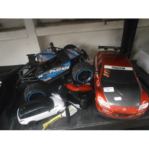 40 - Lot inc four RC cars and helicopter, only 3 controllers