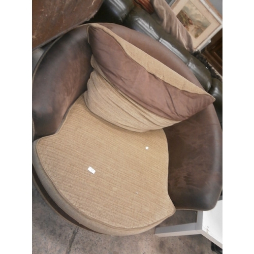 722 - A large cushioned swivel armchair