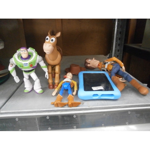 9 - Lot including toy story figurines and a tablet