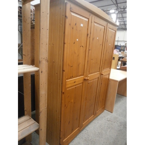 639 - A large pine 3 door wardrobe