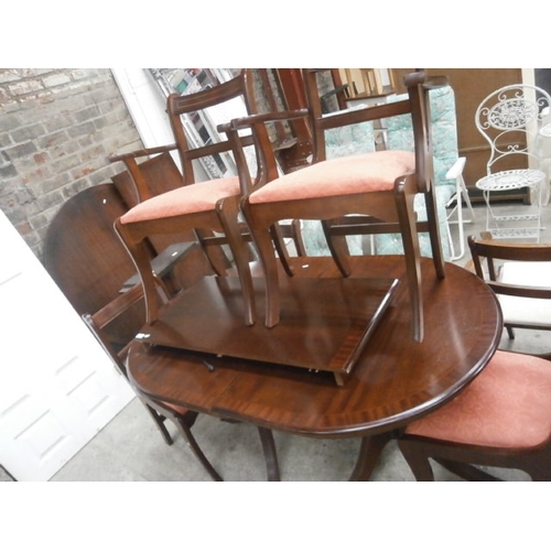 648 - A vintage extending twin pedestal dining table and 6 x sabre legged chairs