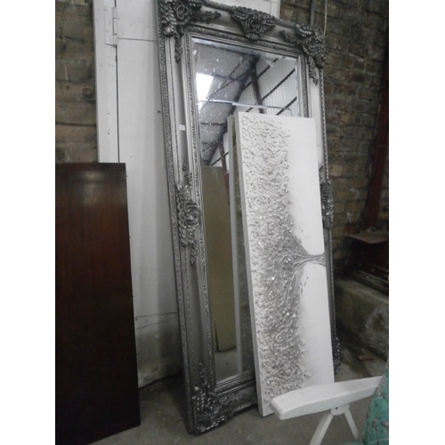 655 - A 2M x 1M bevelled wall mirror in ornate silvered frame and an artwork panel