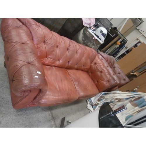 690 - A large red leather WINCHESTER Chesterfield settee and matching armchair - wear and split to arm