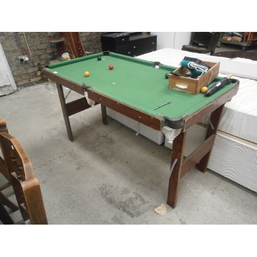 672 - A small snooker table on folding frame with some balls etc