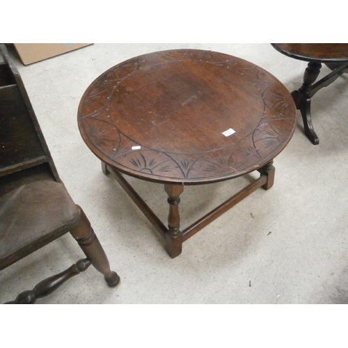 682 - A vintage circular coffee table with carved top