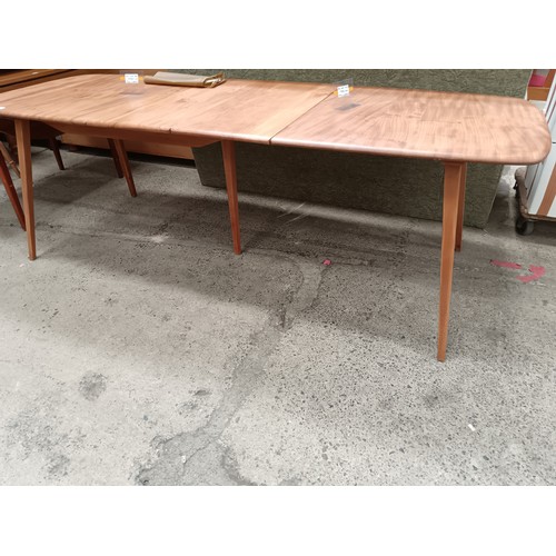 685 - A blond ERCOL Grand Windsor extending dining table with 2 x extension leaves and original fixing bol... 