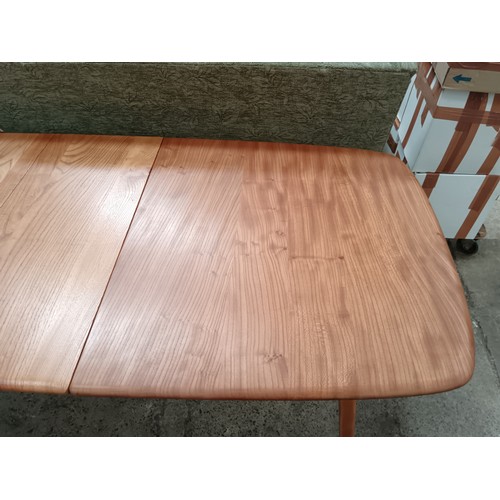 685 - A blond ERCOL Grand Windsor extending dining table with 2 x extension leaves and original fixing bol... 