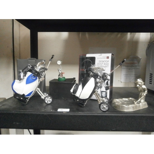 60 - Two desktop golf bag pen sets, miniature golfing clock and metal golfer figurine