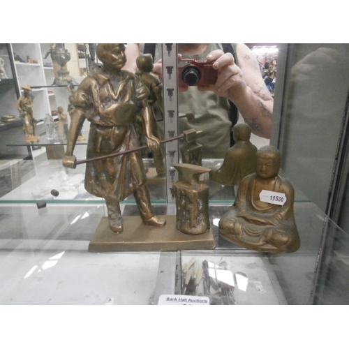 291 - Brass blacksmith and Buddha figurines