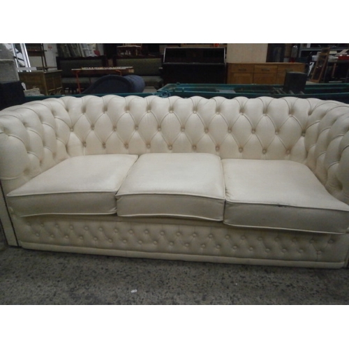 611 - A 3 seater Chesterfield cream leather club style settee