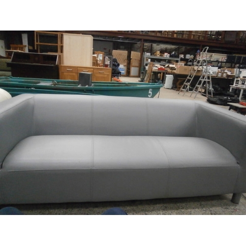 612 - A 3 seater faux leather low back settee - scratches to arm