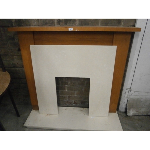 634 - A large wooden fire surround with composite marble back panel and hearth