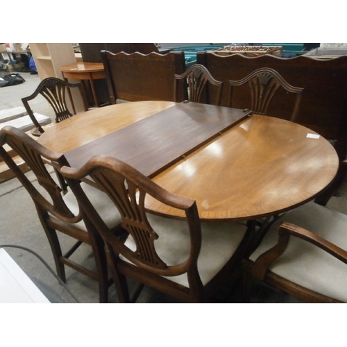 635 - A vintage extending twin pedestal dining table and 6 x matching chairs