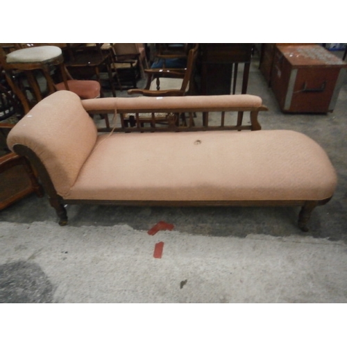 728 - A vintage carved oak framed Chaise Longue with damaged seat cover