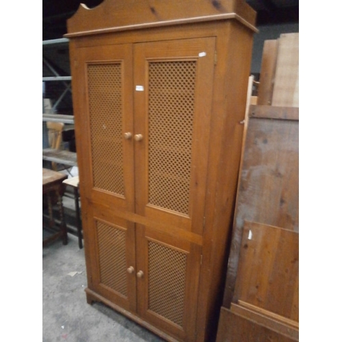 740 - A large solid wooden 4 door cabinet with pierced panels