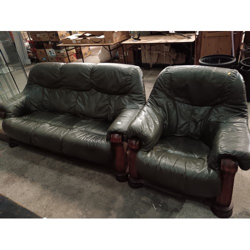 698 - A 3 seater padded leather settee and matching armchair with carved wooden frames