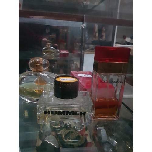 205 - Three assorted part full perfumes including estee lauder intuition, Dolce and gabbana and Hummer aft... 