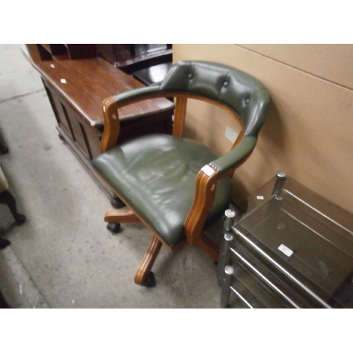 644 - A vintage wood framed green faux leather swivel desk chair - scratches to seat