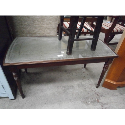 657 - A vintage glass/leather topped coffee table