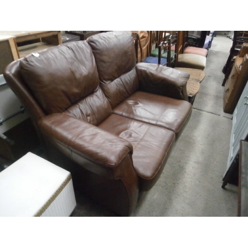 662 - A padded brown leather 2 seater settee