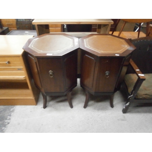 684 - A pair of octagonal leather topped cocktail cupboard stands - a/f tops