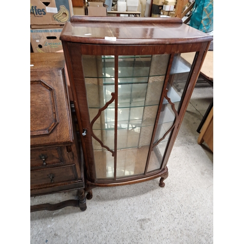 713 - Bow fronted glass display cabinet with shelves and key